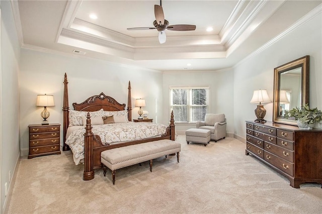 carpeted bedroom with a raised ceiling, ensuite bath, ceiling fan, and crown molding