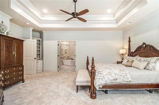 bedroom featuring a tray ceiling, ceiling fan, light colored carpet, and ornamental molding