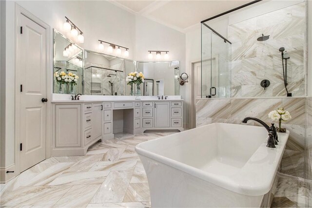 clothes washing area featuring washer and dryer, cabinets, and light tile patterned floors