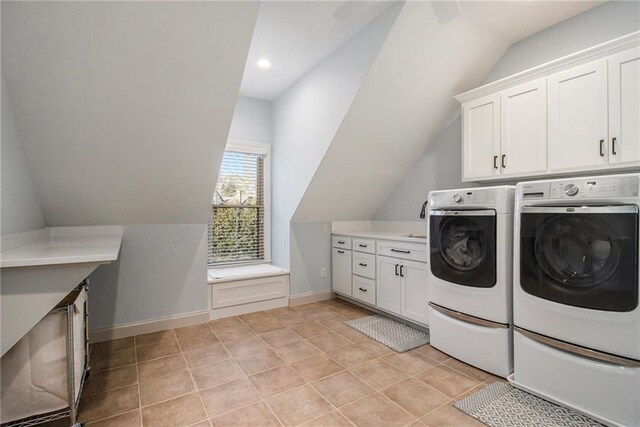 laundry area featuring washer and dryer, ceiling fan, and cabinets