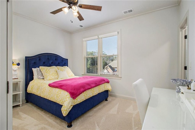 carpeted bedroom with ceiling fan and ornamental molding