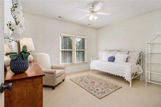 carpeted bedroom featuring a closet, crown molding, and ceiling fan