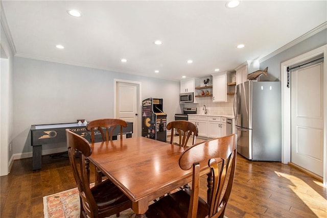 kitchen with dark hardwood / wood-style floors, decorative backsplash, white cabinetry, and appliances with stainless steel finishes