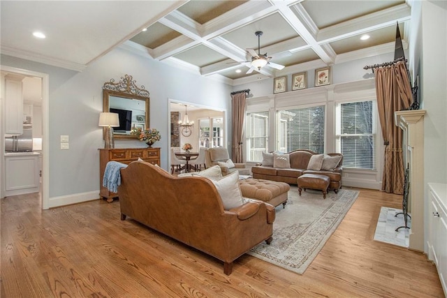 living room with beamed ceiling, ceiling fan with notable chandelier, coffered ceiling, and light hardwood / wood-style flooring