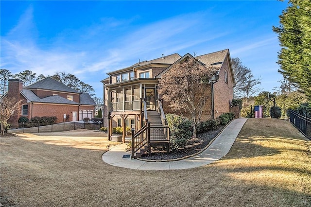 view of front of property with a patio area and a sunroom