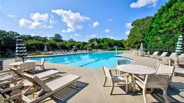 view of swimming pool featuring a gazebo and a water view