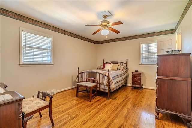 bedroom featuring light wood-style flooring, ornamental molding, ceiling fan, and baseboards