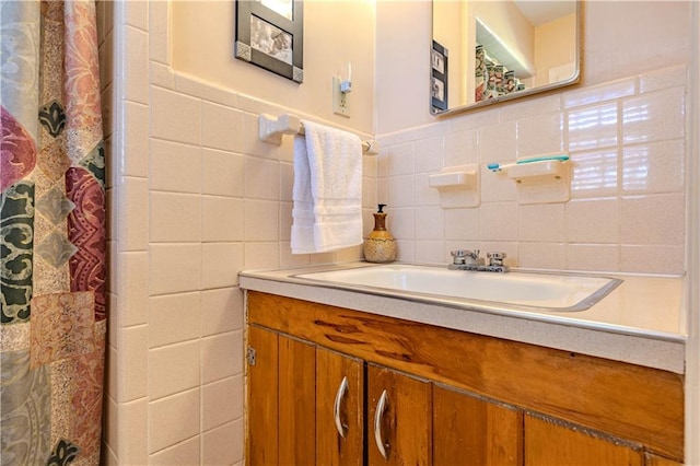 full bathroom with tile walls and vanity