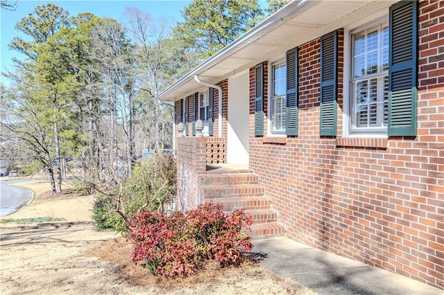 view of exterior entry with brick siding