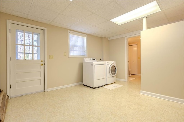 laundry room with light floors, laundry area, baseboards, and independent washer and dryer