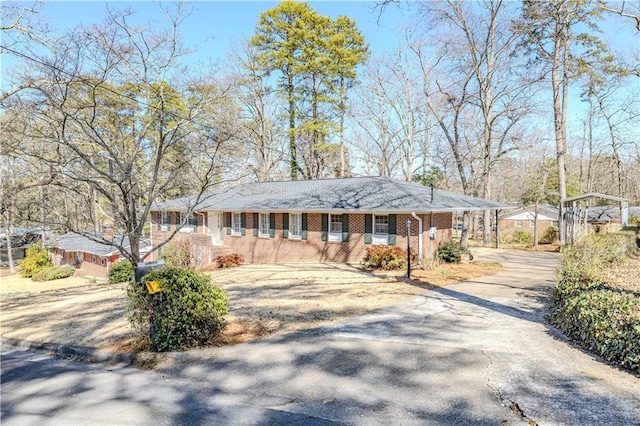 view of front of house featuring brick siding and driveway