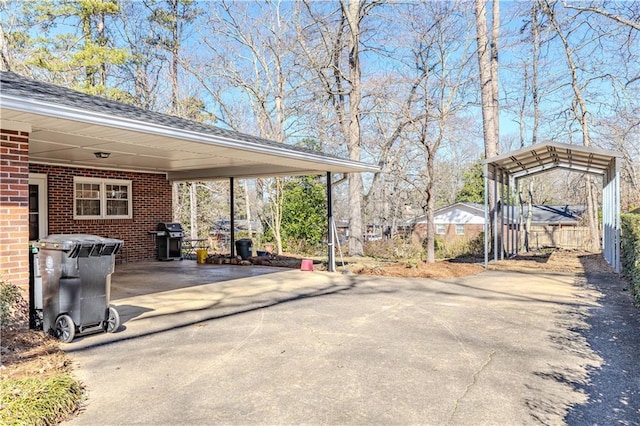 exterior space with fence and aphalt driveway