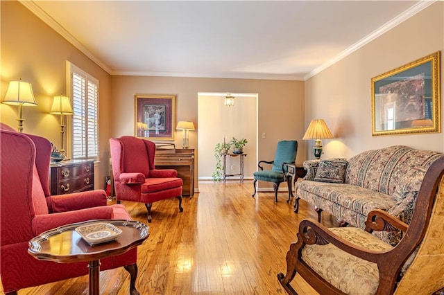 living area featuring ornamental molding and light wood-type flooring