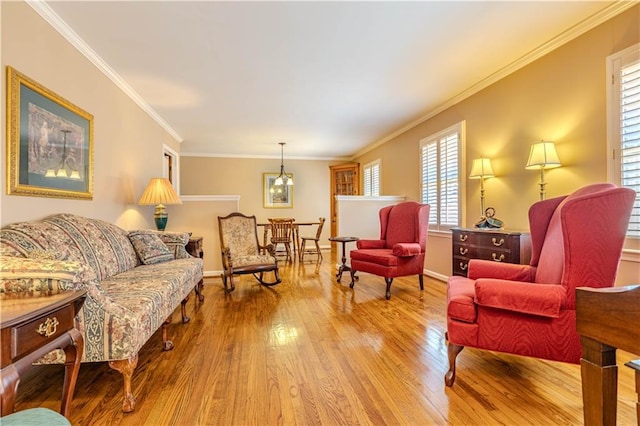 living room with light wood finished floors, baseboards, and ornamental molding