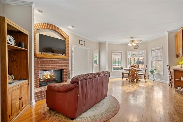 2287 Lake Ridge Ter, Lawrenceville, GA 30043 - living room with a fireplace, a ceiling fan, ornamental molding, light wood-style flooring, and recessed lighting