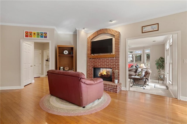 2287 Lake Ridge Ter, Lawrenceville, GA 30043 - living area with light wood finished floors, a fireplace, and crown molding