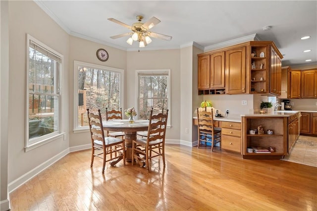 2287 Lake Ridge Ter, Lawrenceville, GA 30043 - dining room with plenty of natural light, ceiling fan, crown molding, light wood-type flooring, and built in desk