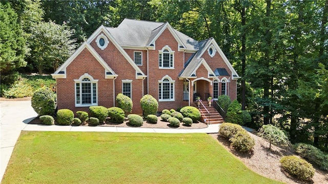 2287 Lake Ridge Ter, Lawrenceville, GA 30043 - view of front facade with brick siding and a front yard