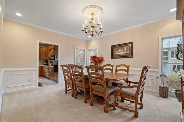 2287 Lake Ridge Ter, Lawrenceville, GA 30043 - dining area with light carpet, crown molding, a chandelier, wainscoting, and a decorative wall