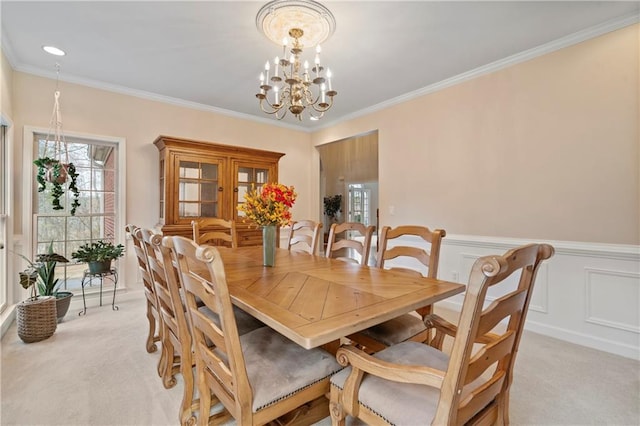 2287 Lake Ridge Ter, Lawrenceville, GA 30043 - dining space with light carpet, a chandelier, crown molding, and wainscoting