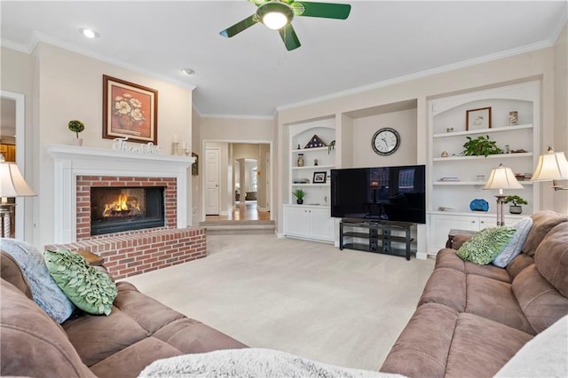 2287 Lake Ridge Ter, Lawrenceville, GA 30043 - carpeted living room with built in shelves, a ceiling fan, crown molding, and a brick fireplace