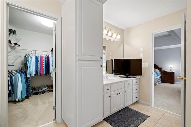 2287 Lake Ridge Ter, Lawrenceville, GA 30043 - ensuite bathroom with vanity, a spacious closet, and tile patterned floors