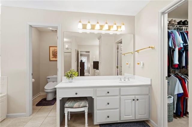 2287 Lake Ridge Ter, Lawrenceville, GA 30043 - bathroom featuring vanity, a spacious closet, and tile patterned floors