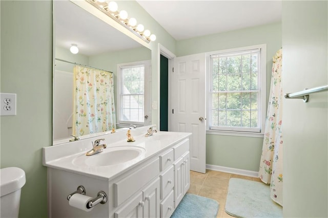 2287 Lake Ridge Ter, Lawrenceville, GA 30043 - bathroom featuring healthy amount of natural light, double vanity, tile patterned flooring, and curtained shower