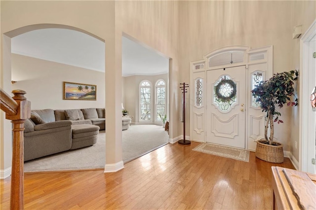 2287 Lake Ridge Ter, Lawrenceville, GA 30043 - entryway with light wood-style floors, a high ceiling, and arched walkways