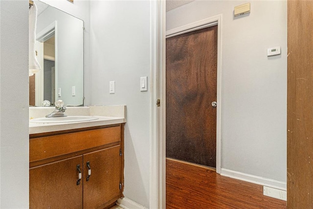 7002 Spout Springs Rd, Flowery Branch, GA 30542 - bathroom with vanity and wood finished floors