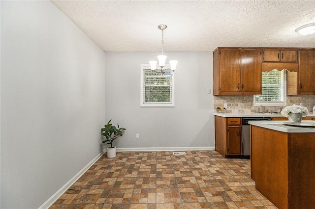7002 Spout Springs Rd, Flowery Branch, GA 30542 - kitchen with dishwasher, light countertops, tasteful backsplash, brown cabinets, and a chandelier