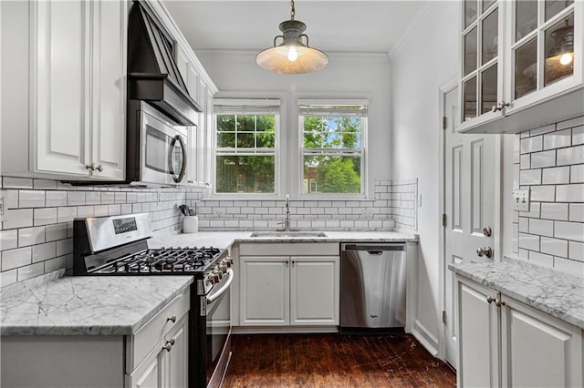 872 Briarcliff Rd NE Unit B2, Atlanta, GA 30306 - kitchen with appliances with stainless steel finishes, decorative backsplash, dark wood-style flooring, crown molding, and glass insert cabinets