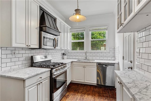 872 Briarcliff Rd NE Unit B2, Atlanta, GA 30306 - kitchen with stainless steel appliances, decorative backsplash, white cabinetry, hanging light fixtures, and ornamental molding