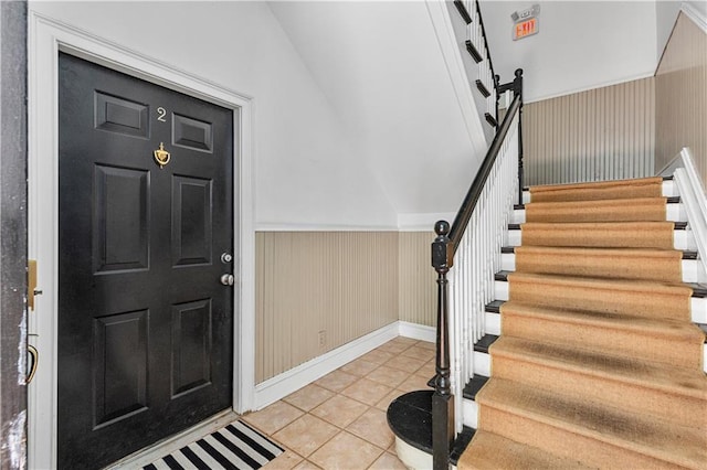 872 Briarcliff Rd NE Unit B2, Atlanta, GA 30306 - entryway with stairway, light tile patterned floors, a wainscoted wall, and vaulted ceiling