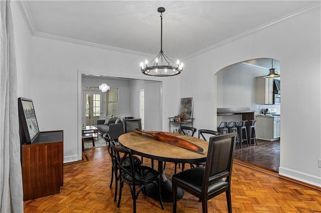 872 Briarcliff Rd NE Unit B2, Atlanta, GA 30306 - dining space with a chandelier, arched walkways, and crown molding