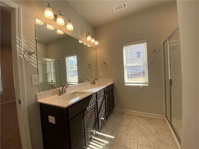 bathroom featuring vanity, tile patterned floors, and a shower with shower door