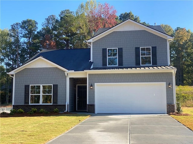 view of front of property with a garage and a front lawn