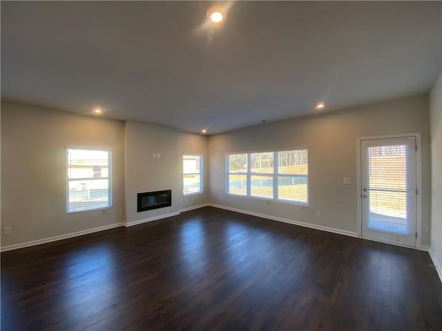 unfurnished living room featuring dark wood-type flooring