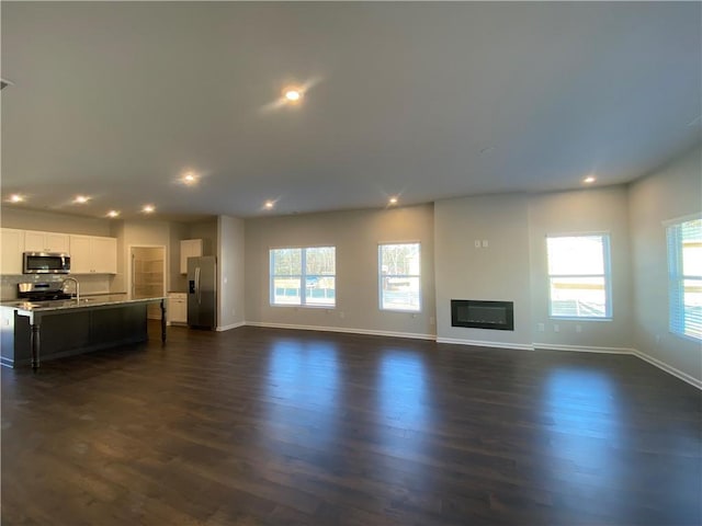 unfurnished living room featuring dark hardwood / wood-style flooring