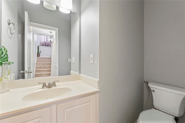 bathroom with toilet and vanity
