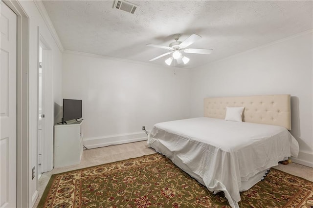 bedroom with light carpet, visible vents, baseboards, and ornamental molding
