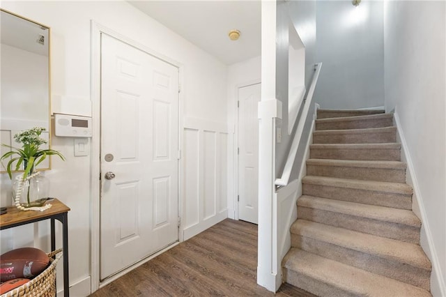 stairs featuring wood finished floors