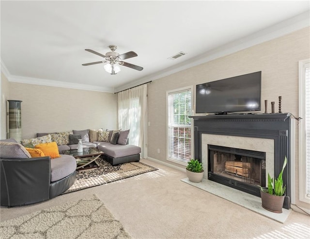 living room with crown molding, a high end fireplace, visible vents, and carpet floors