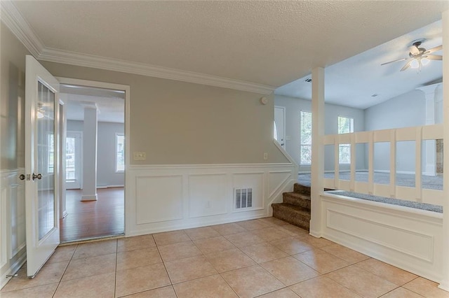 5383 Forest E Ln, Stone Mountain, GA 30088 - spare room with plenty of natural light, light tile patterned flooring, stairway, wainscoting, and a decorative wall