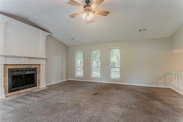 5383 Forest E Ln, Stone Mountain, GA 30088 - unfurnished living room featuring vaulted ceiling, ceiling fan, carpet flooring, and a tile fireplace