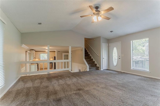 5383 Forest E Ln, Stone Mountain, GA 30088 - unfurnished living room featuring a ceiling fan, carpet, lofted ceiling, stairs, and a textured ceiling
