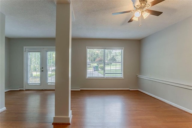 5383 Forest E Ln, Stone Mountain, GA 30088 - empty room with wood finished floors, plenty of natural light, a textured ceiling, and a ceiling fan