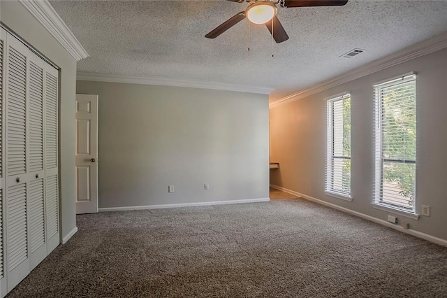 5383 Forest E Ln, Stone Mountain, GA 30088 - unfurnished bedroom with carpet flooring, a textured ceiling, ornamental molding, a closet, and a ceiling fan