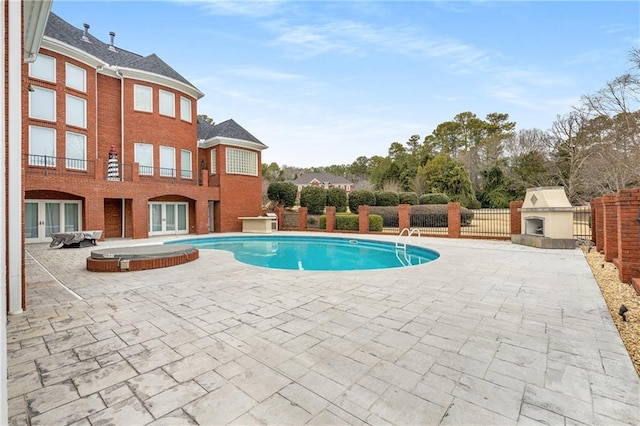 view of pool featuring a fireplace, french doors, and a patio area