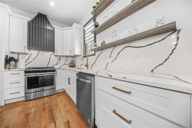 kitchen featuring light stone counters, open shelves, decorative backsplash, appliances with stainless steel finishes, and white cabinetry